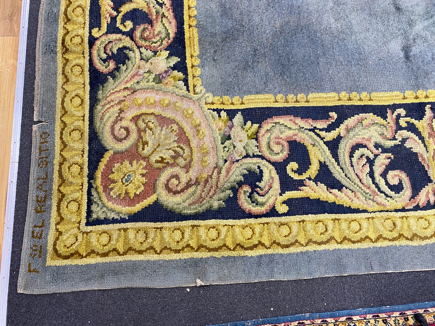 A Spanish polychrome wool carpet marked Aranjuez and dated 1925, 382 x 310cm